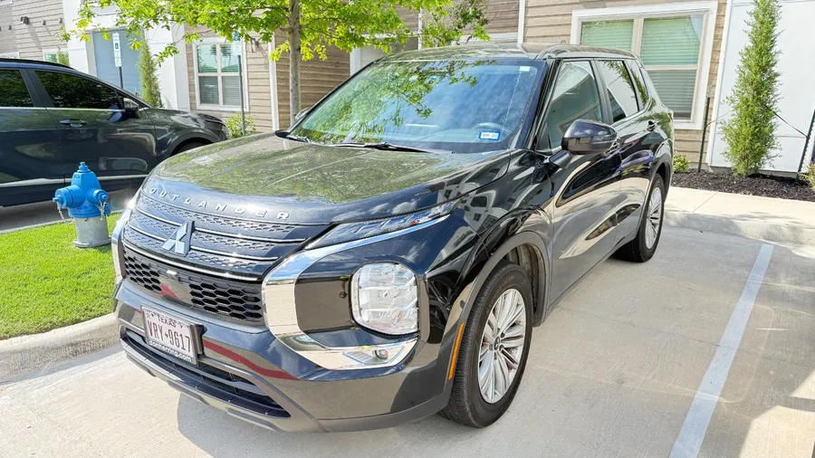 Black Mitsubishi Outlander SUV parked in a North Texas driveway
